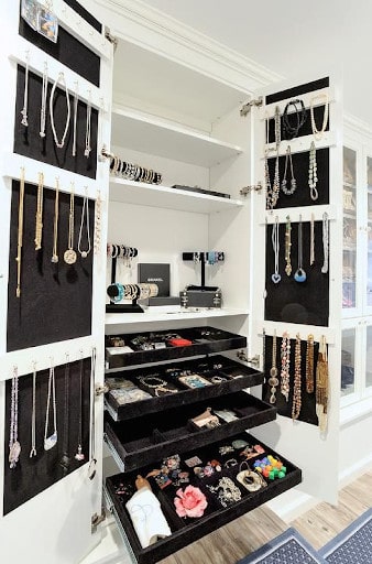 A dedicated jewelry organization system with pull-out displays in a custom closet area.
