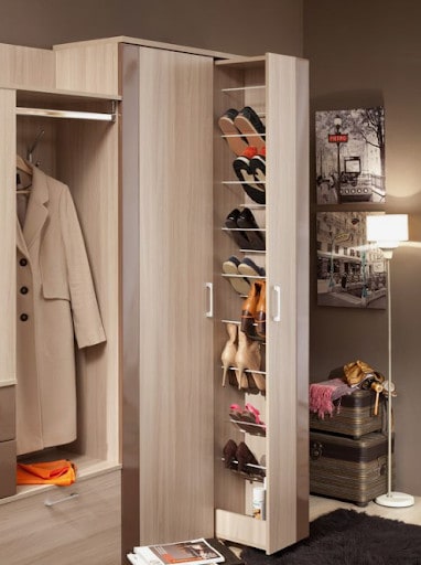 A stylish closet corner with an open shoe organizer and a vintage travel case for a touch of old-school glam.
