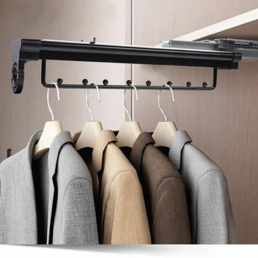 An extendable hanging rod in a streamlined closet, showcasing an efficient use of vertical space in a a small walk in closet