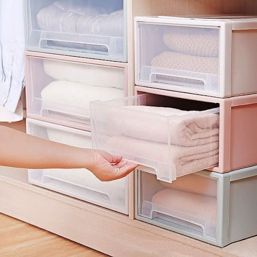 See-through drawers/ Transparent Boxes neatly storing linens, showcasing a tidy and accessible linen closet.
