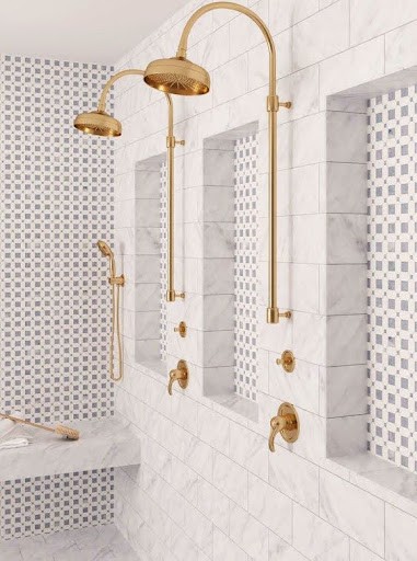 Luxuriously Mosaic Accent Wall appointed small bathroom shower niche with marble tiling and a variety of showerheads, exuding sophistication in a compact form.