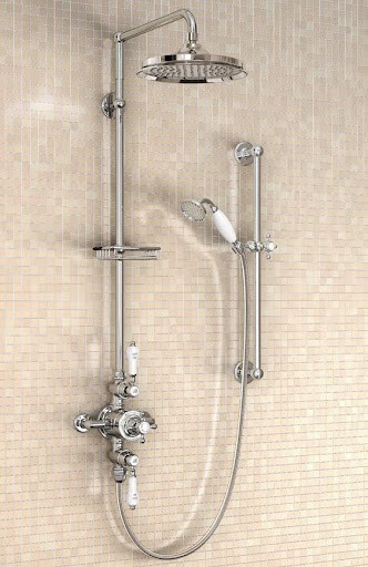 Sophisticated and refined bathroom shower featuring a Expose Plumbing Pipes, luxurious dual-function shower system, complemented by warm, amber-hued mosaic tiling for an opulent bathing experience.