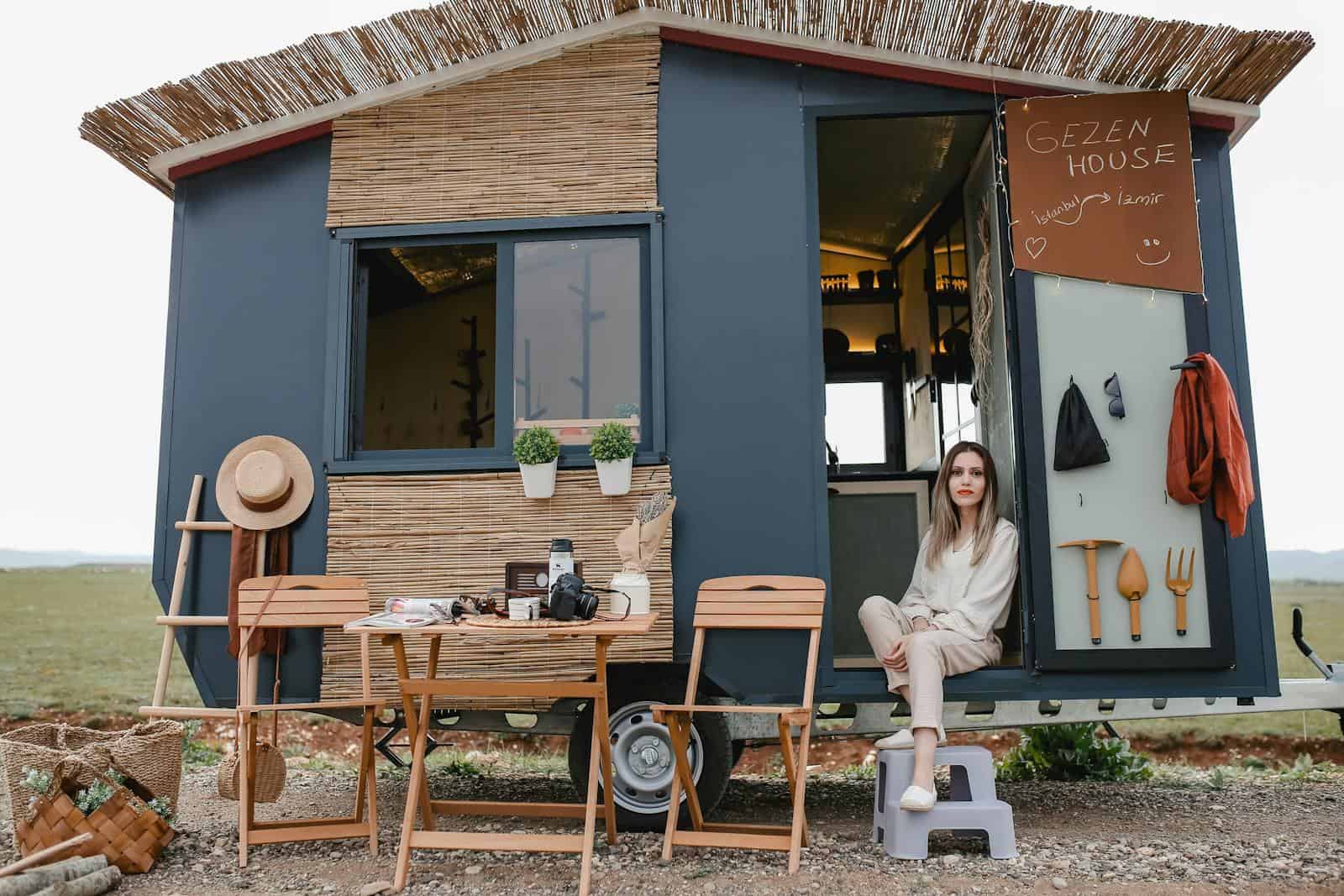 Woman Sitting in a Trailer Converted to a House on Wheels